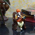 Ganesha Idol Reading Book on Wooden Chair