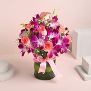 FlowerAura Fresh Live Flower Bouquet of 12 Pink Roses & 4 Purple Flowers In Glass Vase For Birthday Gift, Anniversary Gift, Wedding Gift, Mother's Day Gift & Special Occasions Gift (Same Day Delivery)